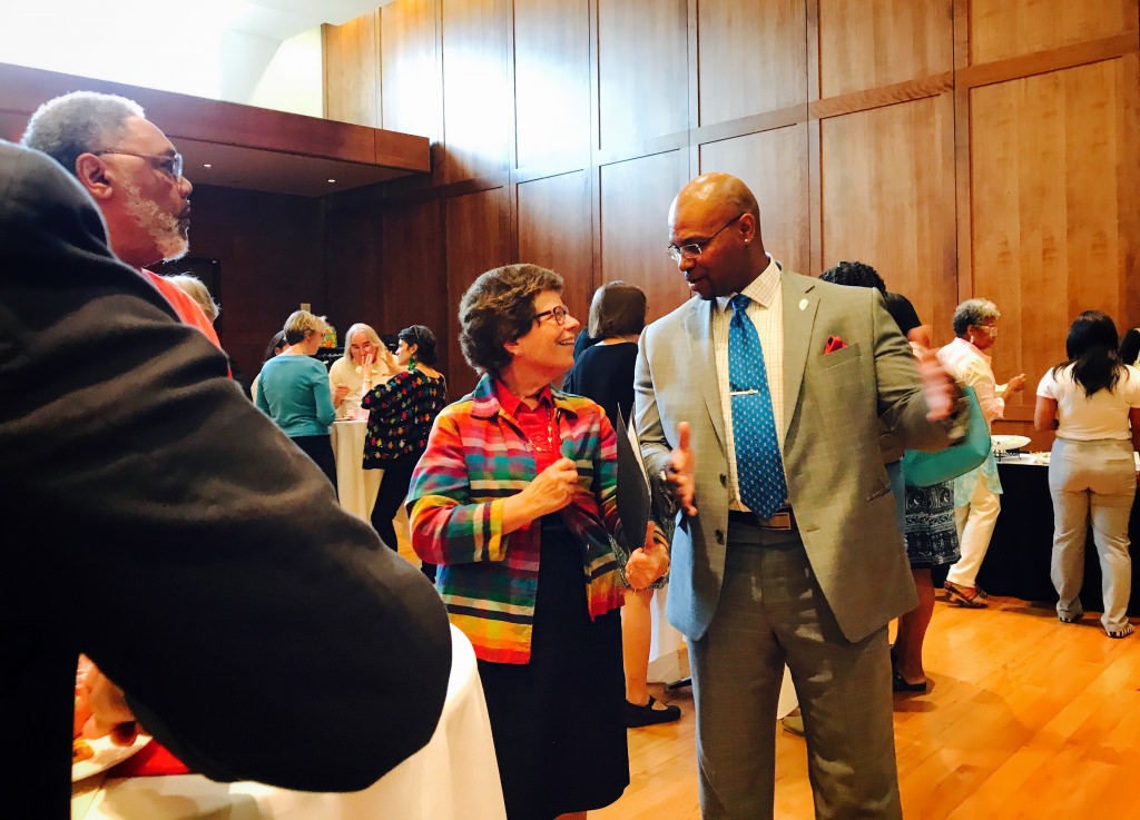Blank talks with Chief Diversity Officer Patrick Sims at the Faculty of Color reception. 