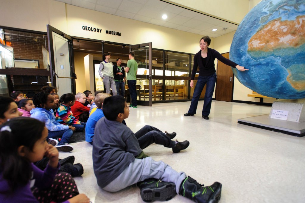 Photo: Brook Norsted talking to students in front of large globe