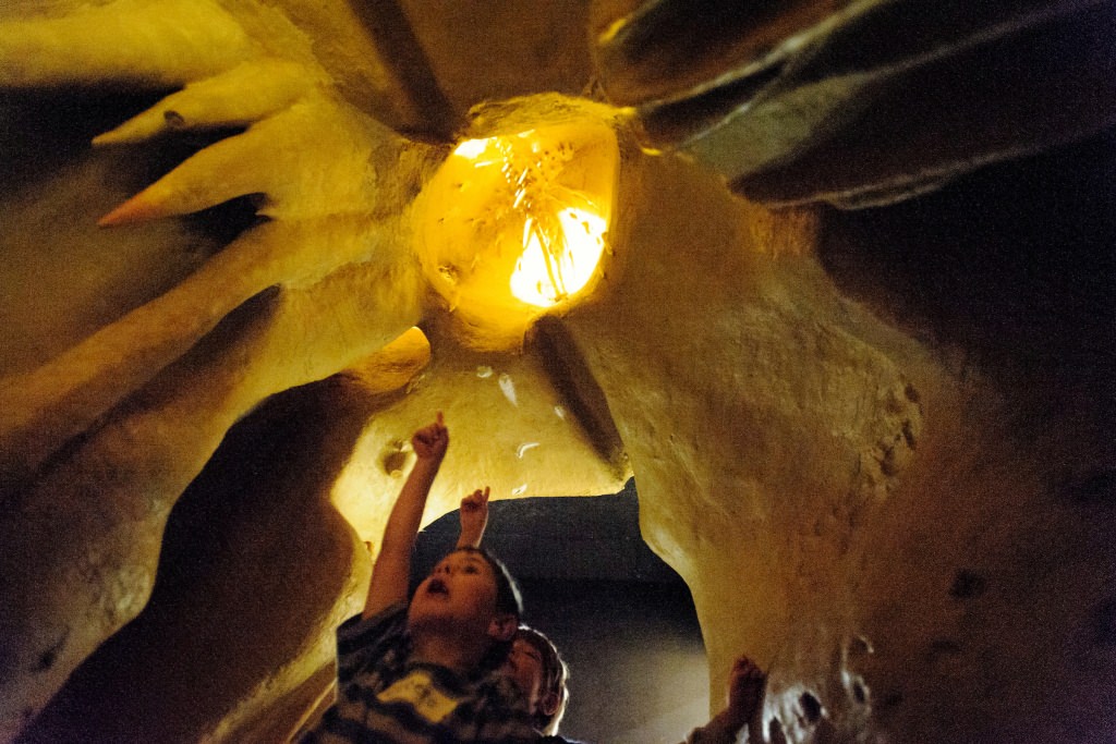 Photo: Children looking up at stalagmite replicas