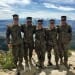 Wisconsin midshipmen take a break from their mountain warfare training to pose for a picture on top of the California Sierras.  From left to right: Colin Knight from New Berlin; Derek Campbell from Green Bay; Scott Brooks from Gross Pointe Farms, Michigan; and John Tilstra from Brandon.