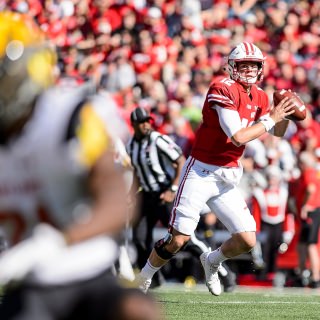 UW quarterback Alex Hornibook (#12) looks for his receiver during the UW Homecoming football games versus Maryland inside Camp Randall Stadium at the University of Wisconsin-Madison on Oct. 21, 2017. The Badgers won the game 38-13. (Photo by Bryce Richter / UW-Madison)