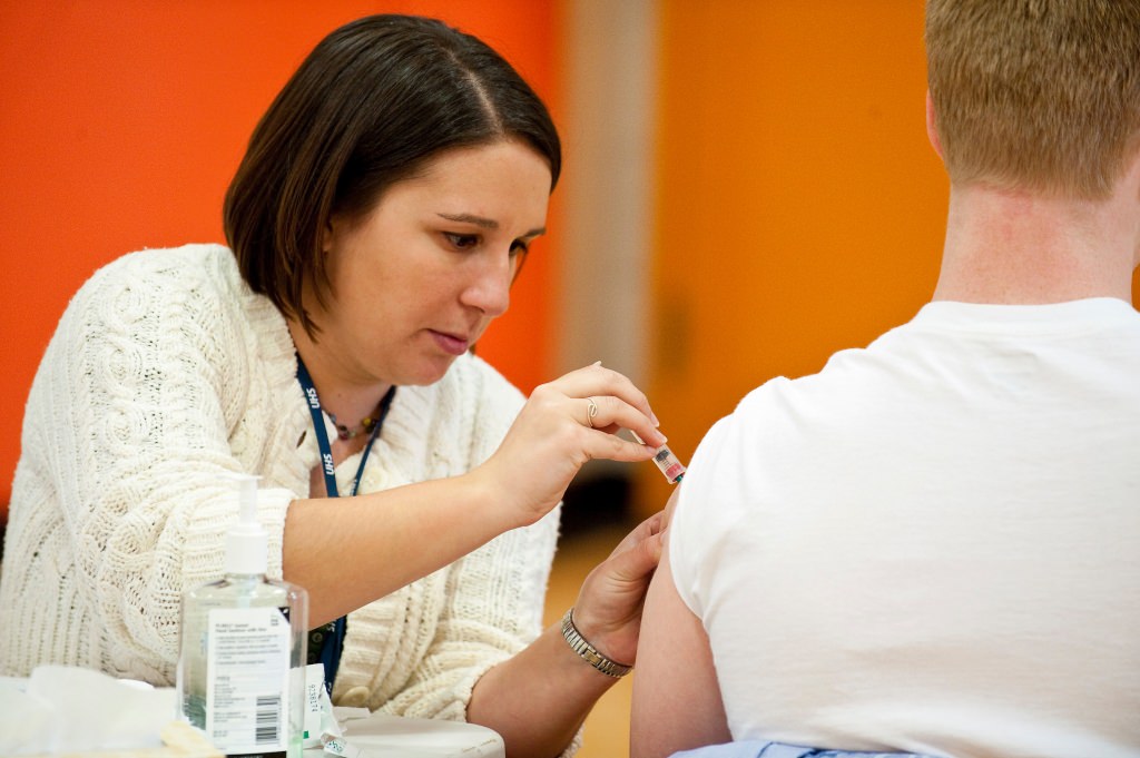 Photo: Nurse administering vaccination in student's arm