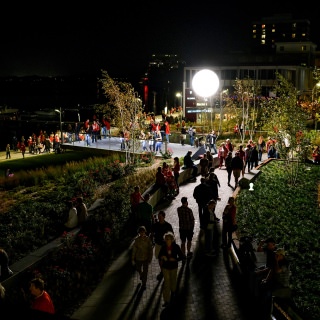 Guests explore the recently-opened Alumni Park and One Alumni Place at the University of Wisconsin-Madison during the UW Homecoming Block Party on Oct. 20, 2017. The event followed the Homecoming Parade that took place earlier in the evening. (Photo by Jeff Miller / UW-Madison)