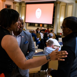 Tracey Williams-Maclin, with UW-Madison Division of Diversity, Equity & Educational Achievement, welcomes back alumni LaMar "Soup" Campbell, center, and Jeff Mack Jr., right, during the Multicultural Homecoming Diversity Celebration at the Memorial Union at the University of Wisconsin-Madison on Oct. 20, 2017. Campbell is a 1998 alumnus and a former Wisconsin football defensive back. Mack Jr. is a 2003 alumnus of the Wisconsin Business School. The event followed the UW Homecoming Parade that took place earlier in the evening. (Photo by Jeff Miller / UW-Madison)