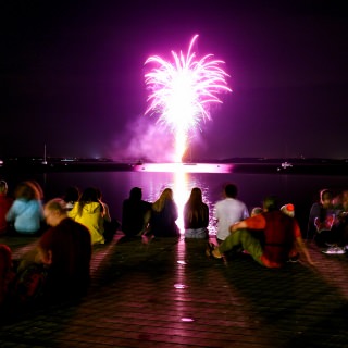 UW-Madison alumni, students and members of the Madison community line Goodspeed Family Pier to take in a firework display over Lake Mendota during the UW Homecoming Block Party at Alumni Park at the University of Wisconsin-Madison on Oct. 20, 2017. The event followed the Homecoming Parade that took place earlier in the evening. (Photo by Jeff Miller / UW-Madison)