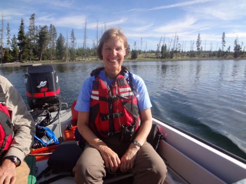 Photo: Monica Turner in life jacket sitting in a boat on an unidentified lake