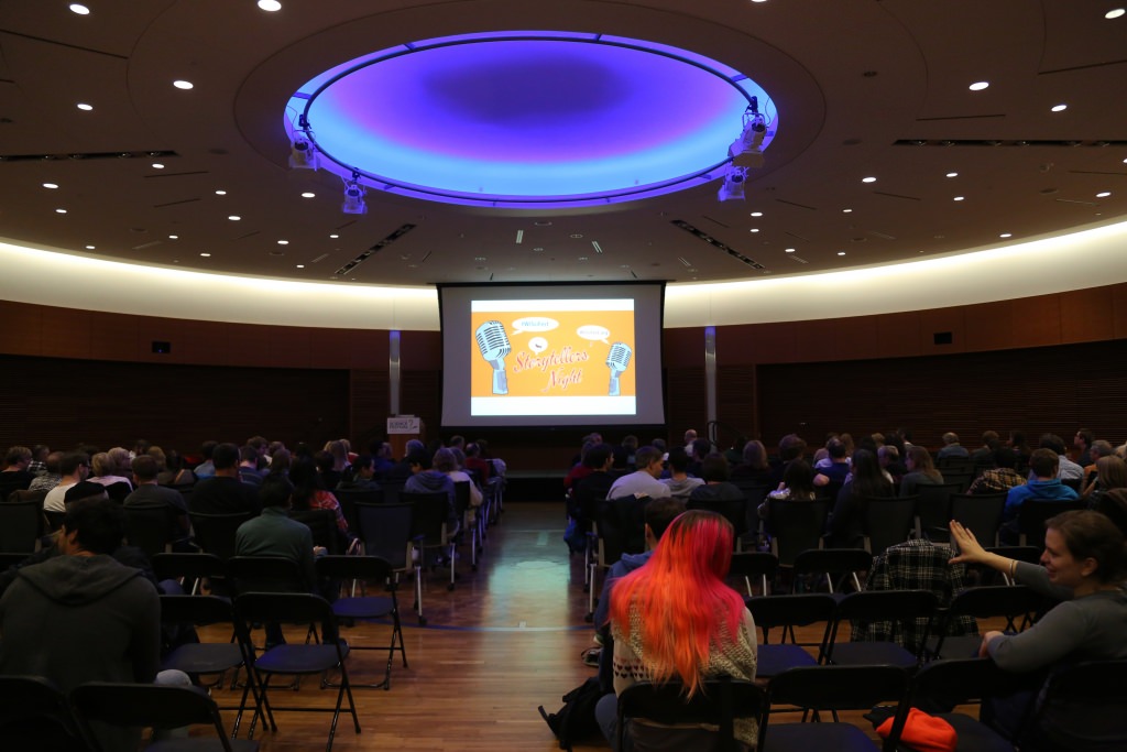 Photo: Storytellers in darkened auditorium