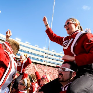 UW Marching Band member Mara Matovich gets into the "Jump Around" spirit as the Wisconsin Badgers take on the Maryland Terrapins during a UW Homecoming football game at Camp Randall Stadium at the University of Wisconsin-Madison on Oct. 21, 2017. Wisconsin won the game, 38-13. (Photo by Jeff Miller / UW-Madison)