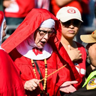 Badger fans known as "The Sisters of Chryst" chat with Dane County Sheriff David Mahoney as the Wisconsin Badgers take on the Maryland Terrapins during a UW Homecoming football game at Camp Randall Stadium at the University of Wisconsin-Madison on Oct. 21, 2017. Wisconsin won the game, 38-13. (Photo by Jeff Miller / UW-Madison)