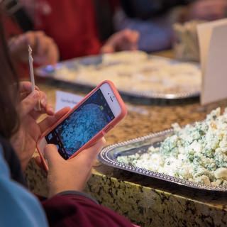Participant of the Life of Cheese: A Tasting and Science of Cheese takes a picture of Emmi Roth Buttermilk Blue Cheese during the event at Discovery Building's Steenbock's on Orchard Restaurant in Madison, WI. Saturday, Nov. 4, 2017. This event was about an exploration and tasting of cheese as it ages, from cheese curds to Parmesan-Reggiano. This event is put on by the Wisconsin Science Festival and Steenbock’s on Orchard exclusively for Family Weekend, and it was sold-out. (Photo by Hyunsoo Léo Kim | University Communications)