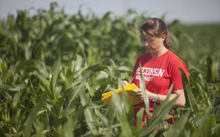 Photo: Natalia de Leon taking notes in cornfield