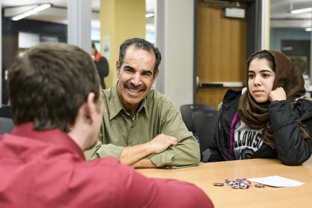 Lea Polizzi (left), student services coordinator in the Office of Student Financial Aid at the University of Wisconsin-Madison, talks with prospective student Leena Kheraz (right) and her father Abe Kheraz (center) during a UW community event designed to inform prospective college students about admissions and financial assistance. The event was held at the Goodman Branch of the Madison Public Library on Nov. 13, 2017. (Photo by Bryce Richter / UW-Madison)