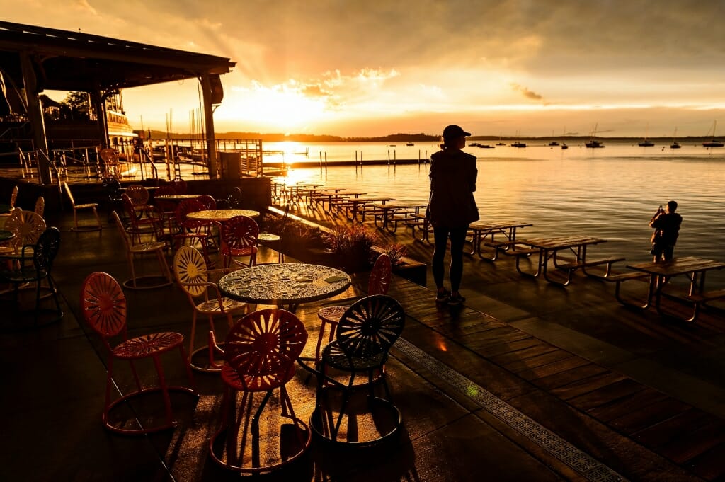 Photo: Water droplets on table on Memorial Union Terrace with sun setting