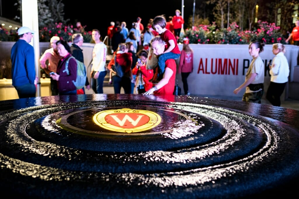 Photo: People standing around a water fountain with W crest