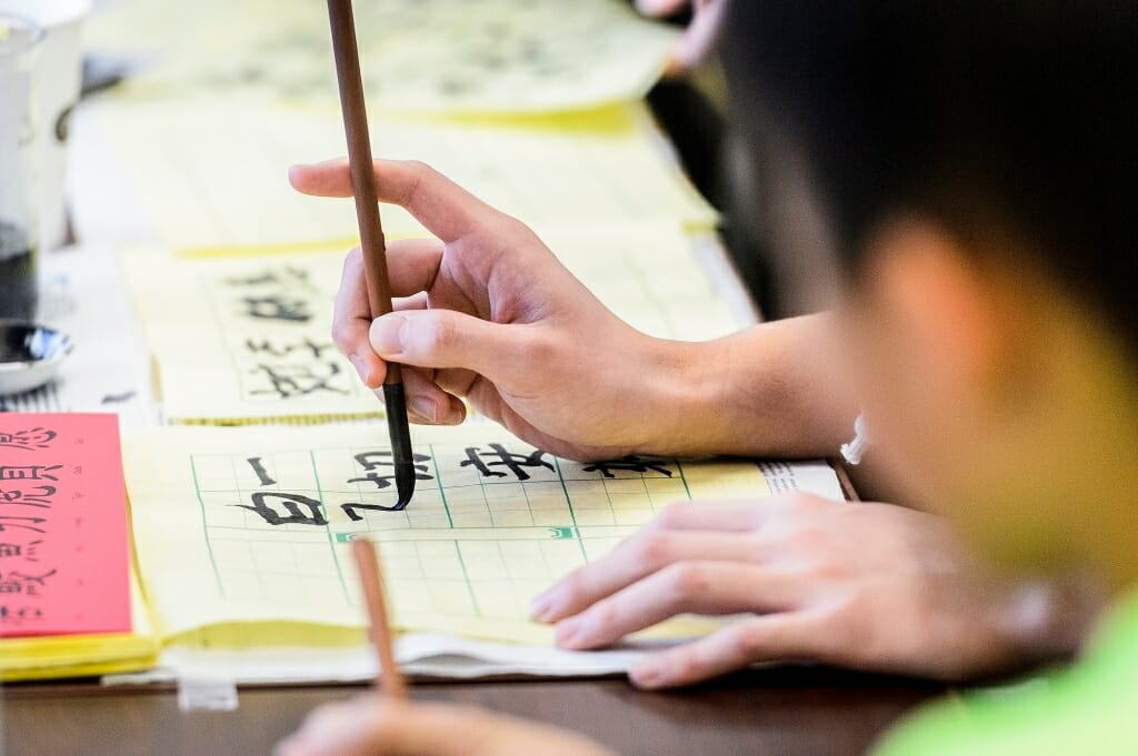 Photo: Close-up of person writing Chinese characters