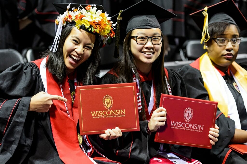 Chancellor's Scholars Cathryn Phouybanhdyt, left, and Joann Huynh show off their diploma covers.
