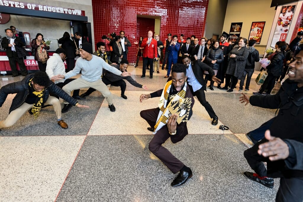 Members of Alpha Phi Alpha perform a stroll in honor of graduate Keven Stonewall, at right of center.