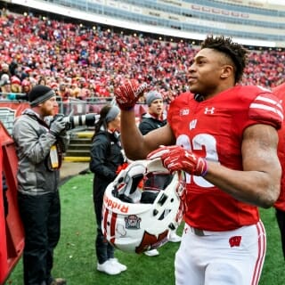 Wisconsin running back Jonathan Taylor (23) waves to cheering fans. Taylor, a freshman, led the Big Ten in rushing yards.