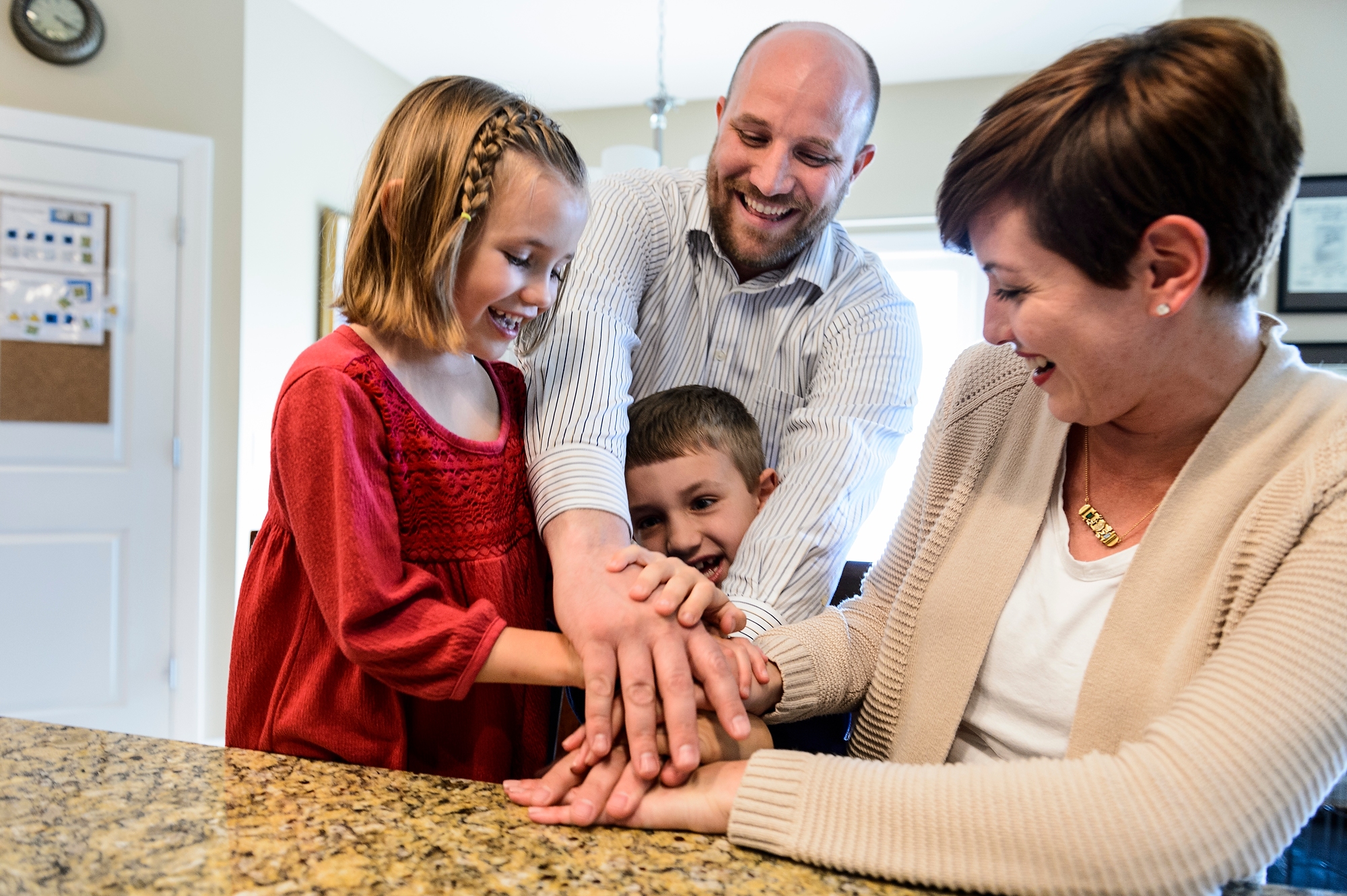 Photo of Mason at home with his parents and sister Alexandra, 5.
