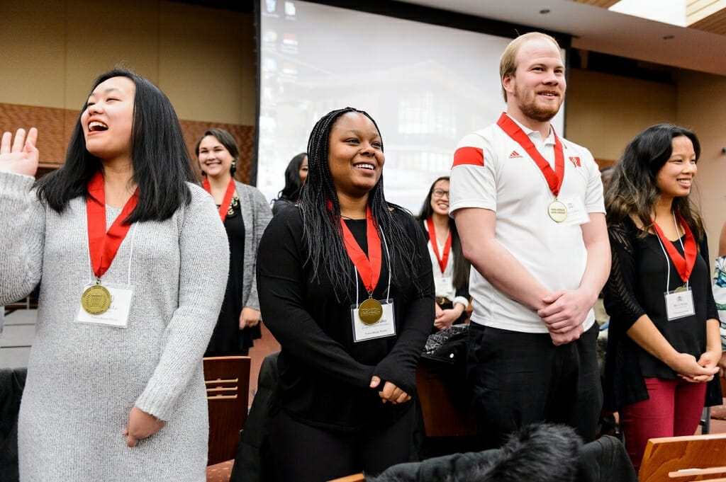 From left to right, Powers-Knapp Scholars Maikou Lo, Alexis Handley, Derek Guillen and Mei Li Brown are recognized among other soon-to-be-graduating students in the Chancellor's Scholars (CS) and Powers-Knapp Scholars (PKS) programs during a CS-PKS event at the Gordon Dining and Event Center at the University of Wisconsin-Madison on Dec. 10, 2017. In total, 14 Chancellor's Scholars and 13 Powers-Knapp Scholars will be receiving their degrees during the UW-Madison winter commencement ceremony on Dec. 17, 2017. (Photo by Jeff Miller / UW-Madison)