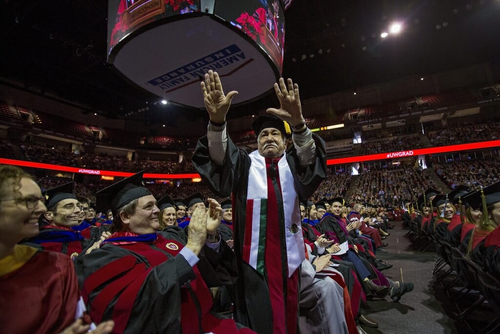 Photo of Barraza waving as Chancellor Blank gives him a shout-out during her speech.