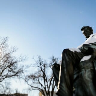 A blanket of freshly-fallen snow coats the Abraham Lincoln statue as the winter-morning sunlight shines through bare tree branches on Bascom Hill at the University of Wisconsin-Madison on Jan. 16, 2018. The photograph was made using a tilt/shift-focus lens. (Photo by Jeff Miller / UW-Madison)