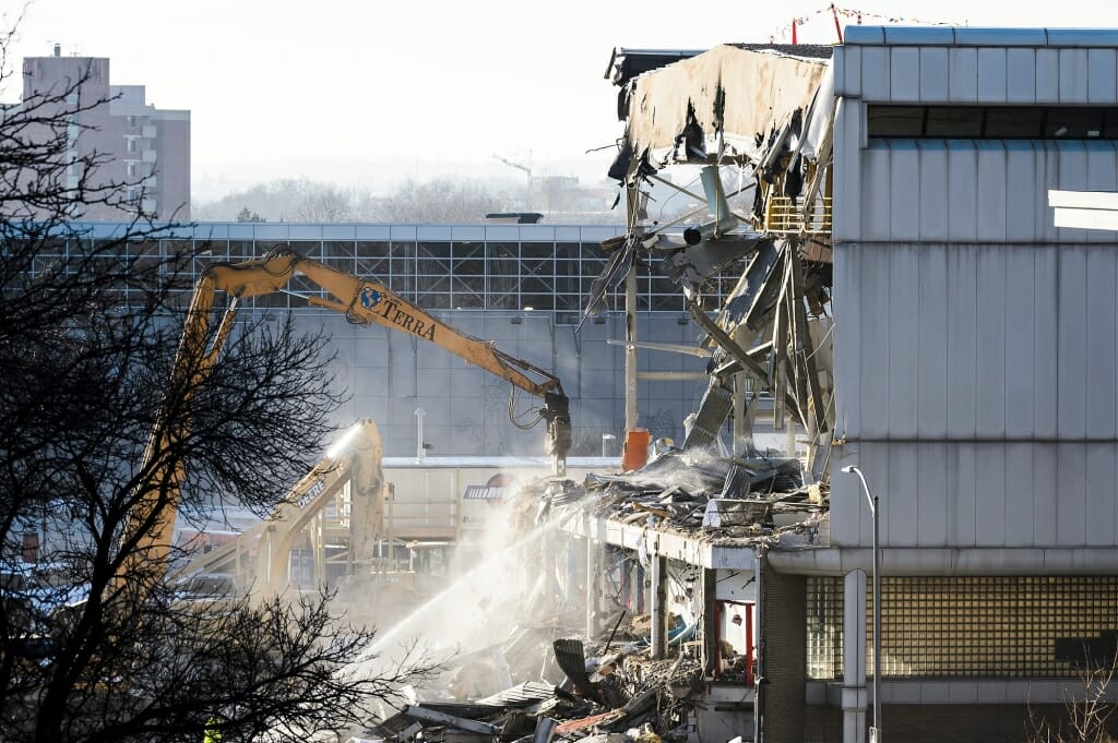 Work crews use heavy-construction equipment to demolish the 34-year-old Southeast Recreational Facility on Jan. 8. The dated building is being replaced by a new fitness facility with nearly four times as much space to be constructed at the same site and open in 2020. 