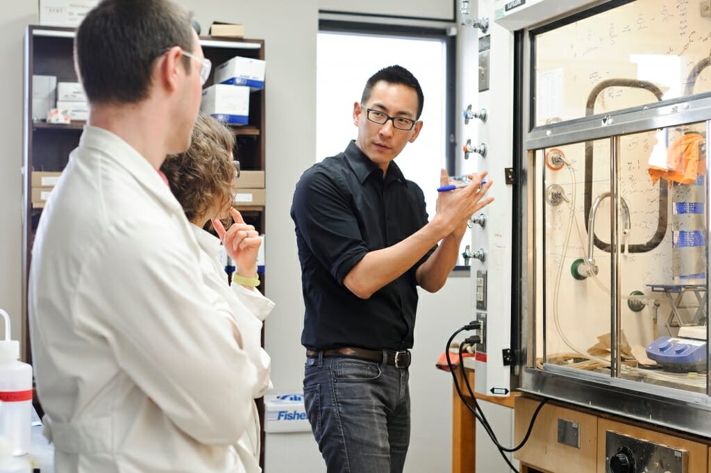 Photo: Tehshik Yoon gesturing at chemistry display