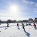 Photo of students facing off during the pond hockey tournament on Lake Mendota.