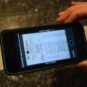 A receipt is photographed and transmitted via a cell phone's Fetch Rewards app.