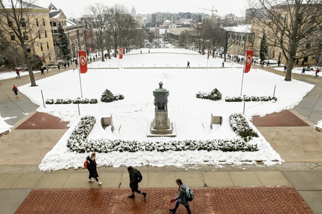 Students make their way to and from classes on Bascom Hill following Tuesday's snowfall.
