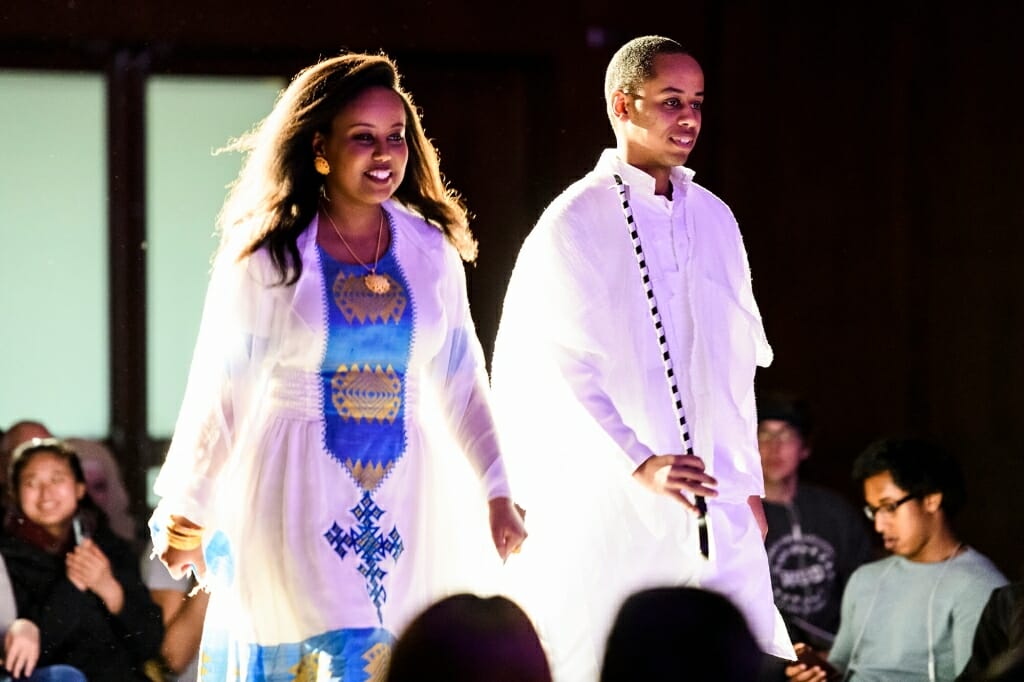 Student volunteers Dahlia Tesfamichael, left, and Negassi Tesfamichael model clothing traditional to  Eritrea. Dahlia is wearing a zuria dress, and Negassi wears an egetebab, which consists of a linen shirt and trousers.