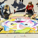 Students work on their chalk art murals featuring Bucky Badger and other campus icons during Badgers Chalk the Block, an All-Campus Party event on Library Mall. 