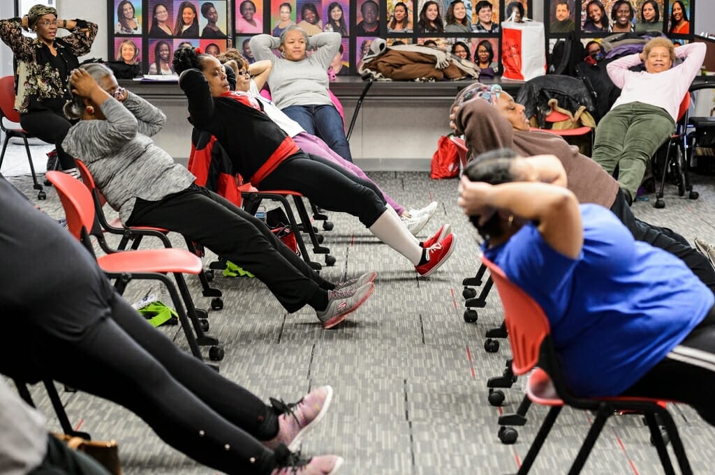 Photo: participants perform chair-based abdominal crunches