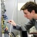 Colin Adams, a UW-Madison physics undergraduate, makes an adjustment to a novel prototype camera that will be used to image the fleeting signatures of gamma rays crashing into molecules of air in the Earth’s atmosphere, creating a shower of diagnostic secondary particles. 