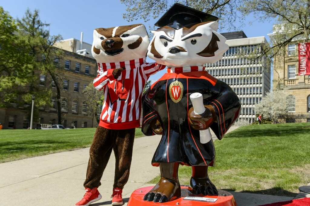 Photo of Bucky posing next to the statue.