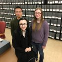  

UW–Madison students Yiqi Yu, left, Laura Huff, right, and Avery Pilot, foreground, helped campus archivists undertake a public oral history project tied to the 50th anniversary of the Dow Chemical Company protests on campus.