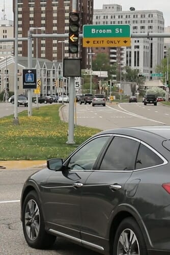 Photo: Car in intersection at yellow arrow on traffic signal
