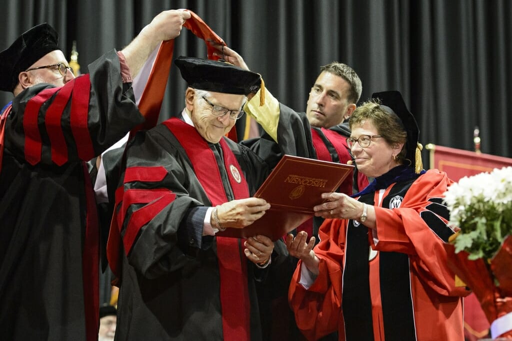 Photo of Jerome Chazen, founding partner and chairman of Liz Claiborne Inc., receiving an honorary degree from Chancellor Rebecca Blank.