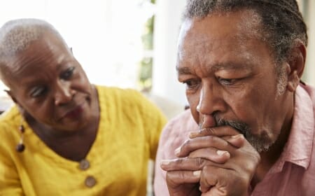Photo: A concerned woman looking at a troubled man