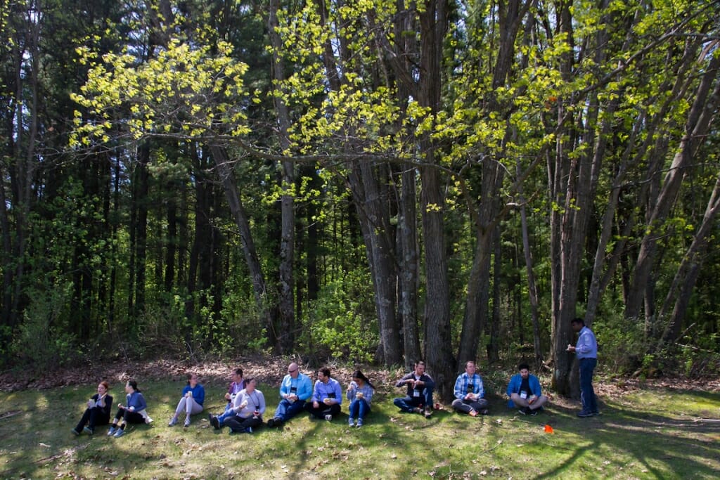 Photo: Group of people sitting on ground eating