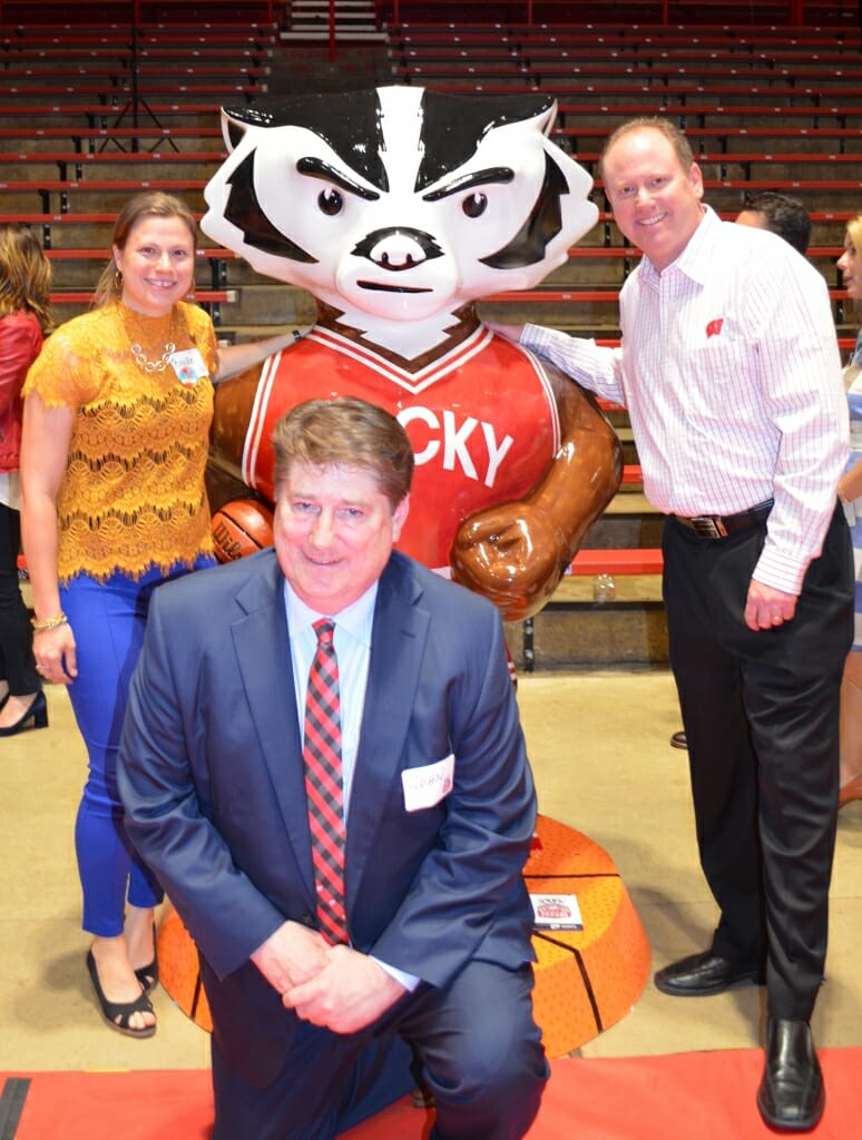 Wentland, Sheehan and Coach Greg Gard, whose charity Garding Against Cancer will receive proceeds from the sales of Bucky on Parade statues, stand next to Baller Bucky at an unveiling event at the Field House. 
