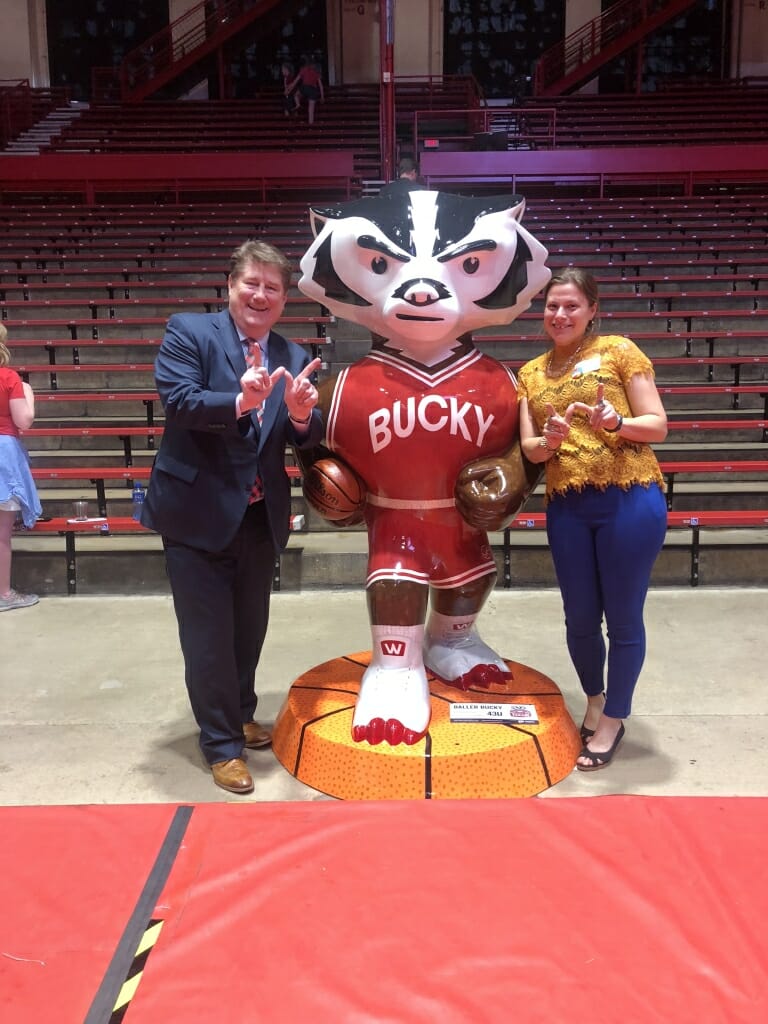 Artist Brooke Wentland and John Sheehan, who sponsored the Bucky, stand next to Baller Bucky at an unveiling event at the Field House.