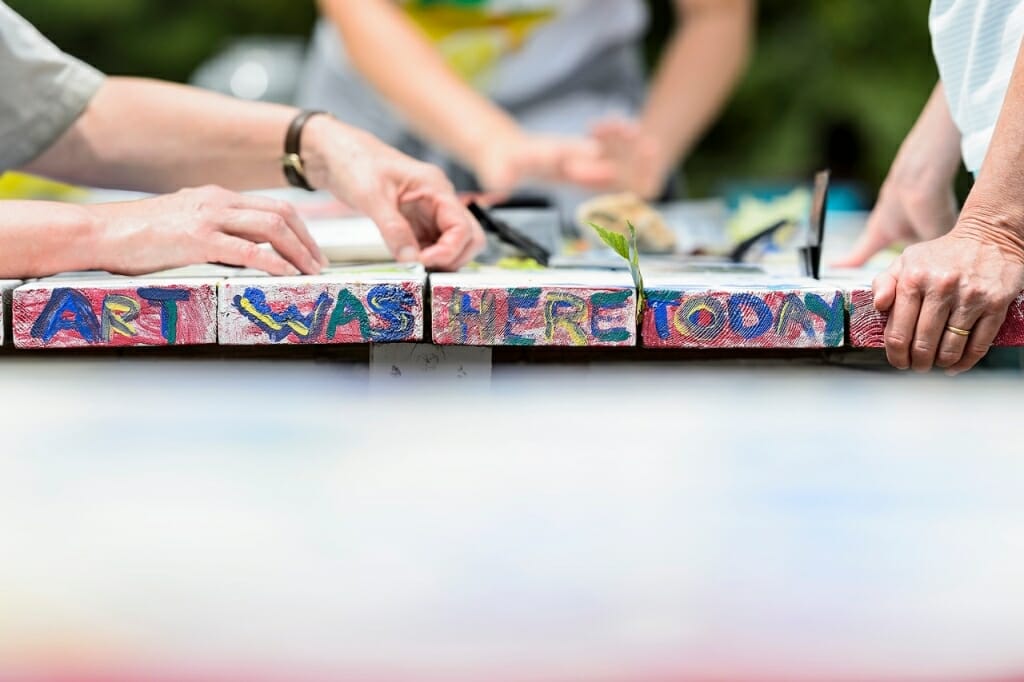 Visitors prepare to make their sunprints on a table at Allen Centennial Garden that is itself a work of art.