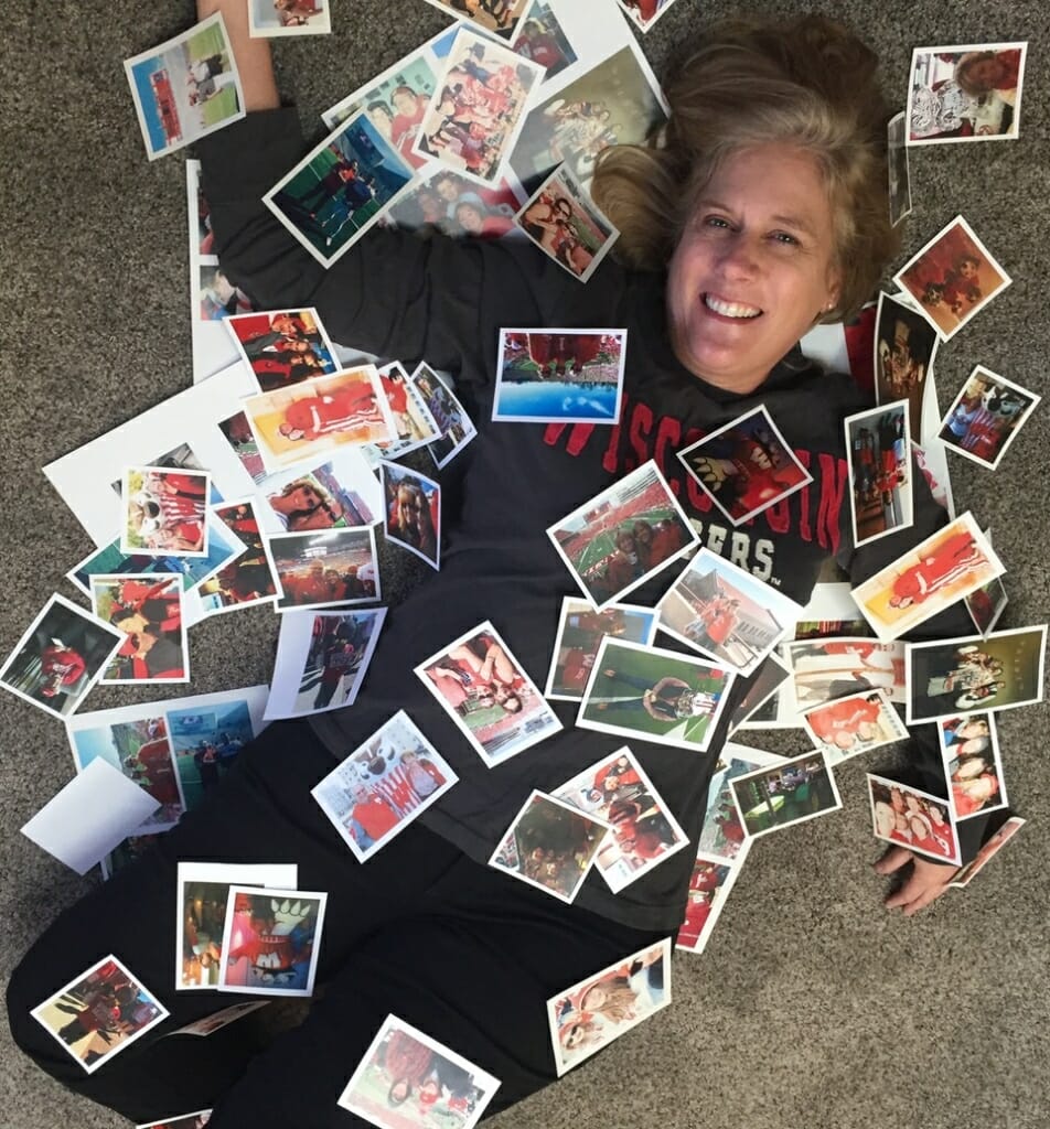 Marie under a pile of postcards, which she used to cover "We Are Bucky" head to toe. 