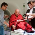 A new study using functional resonance imaging shows differences in the emotion networks of the brain in people who don't meditate, people new to meditation, and people considered long-term meditators, who have thousands of lifetime experience with mindfulness meditation. Pictured is Matthieu Ricard, a buddhist monk, who has participated in similar studies at the UW–Madison Center for Healthy Minds. Among those helping him into the MRI is Richard Davidson, with jacket, who's led the work. The study monitors a subject's brain activity and the impact of meditation.