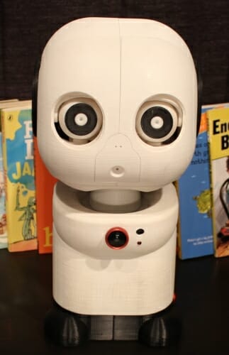 Photo: Closeup of robot in front of several books