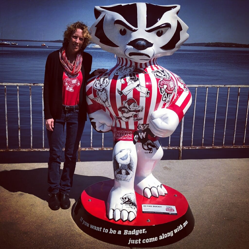 S.V. Medaris stands next to Retro Bucky, which she designed for the public art project Bucky on Parade. Retro Bucky is one of 85 unique life-size Bucky Badger statues located around Wisconsin.