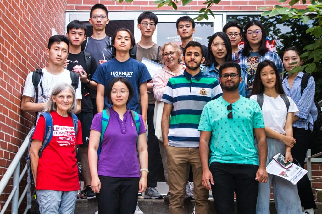 The students in the International Student Summer Institute pose on the stairs of Babcock Hall. 