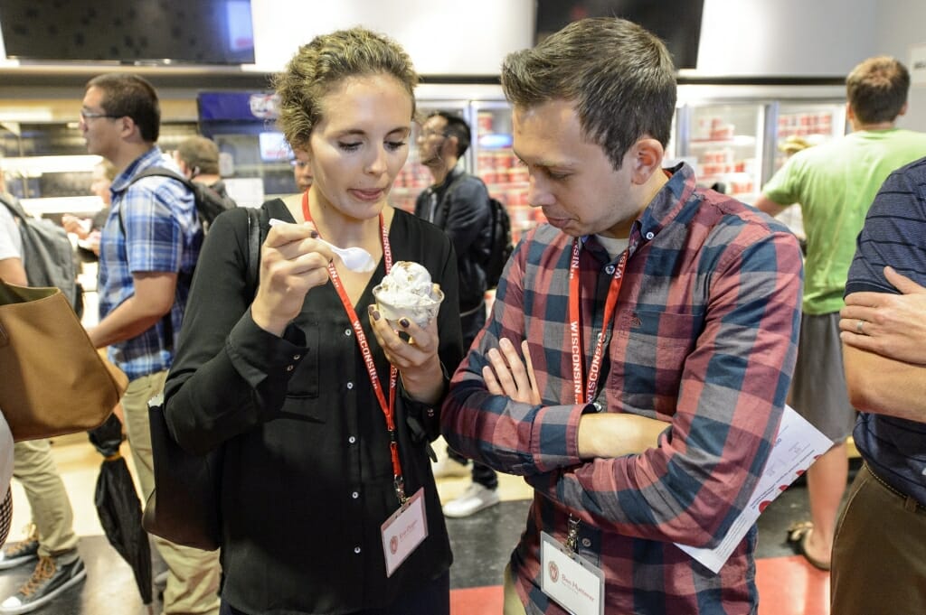 Photo: One person eating a small dish of ice cream while another person stares at it intently